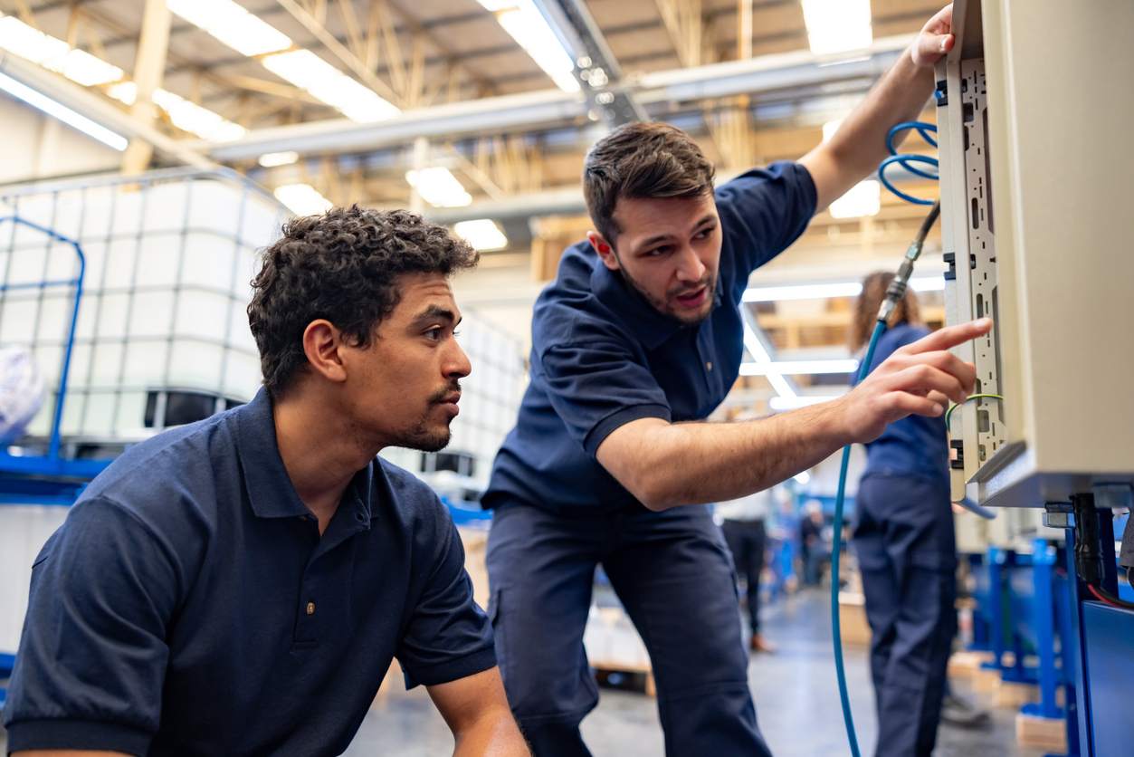 iStock-1828384788 blue collar electricians working together