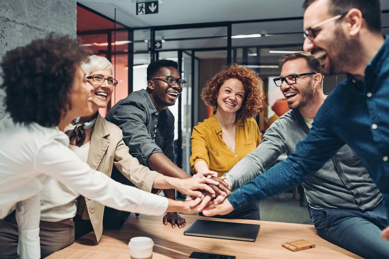 iStock-1373240838 group stacking hands in office