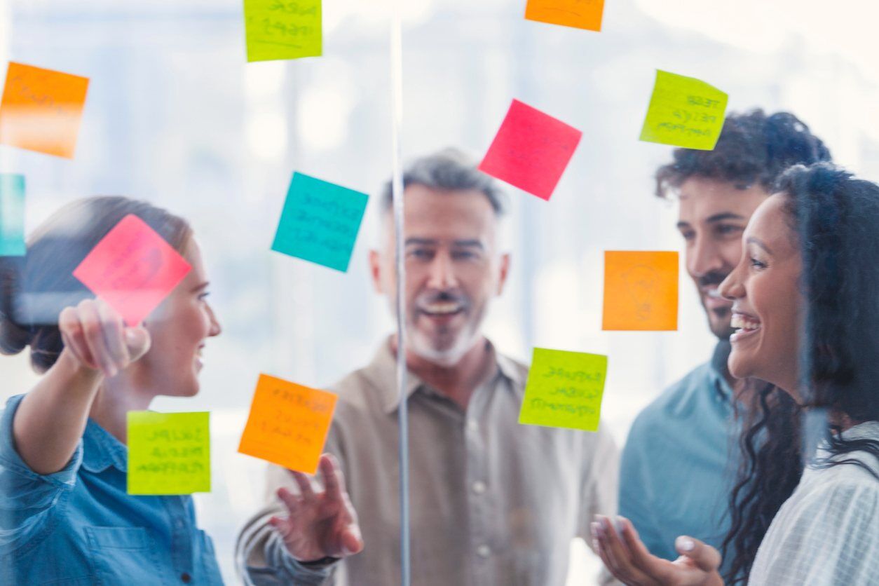 iStock-1371160684 Group discussion around sticky notes